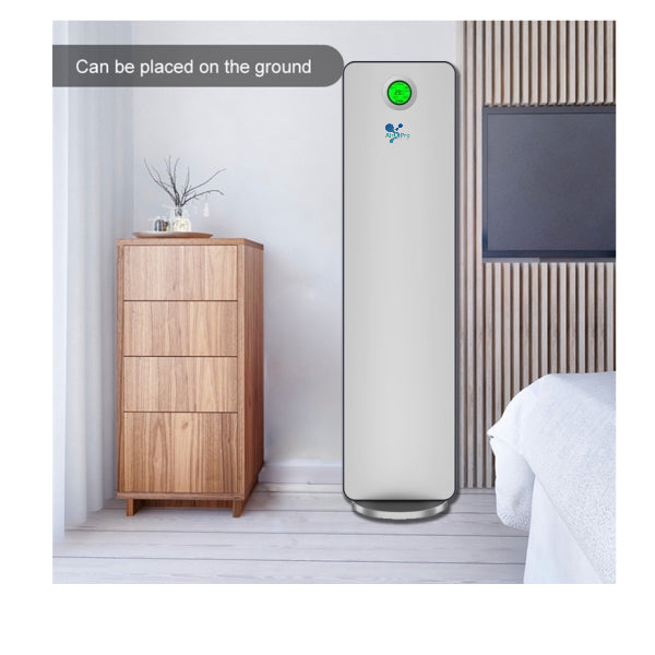 Tall white air purifier with green light indicator on a wooden cabinet in a room.